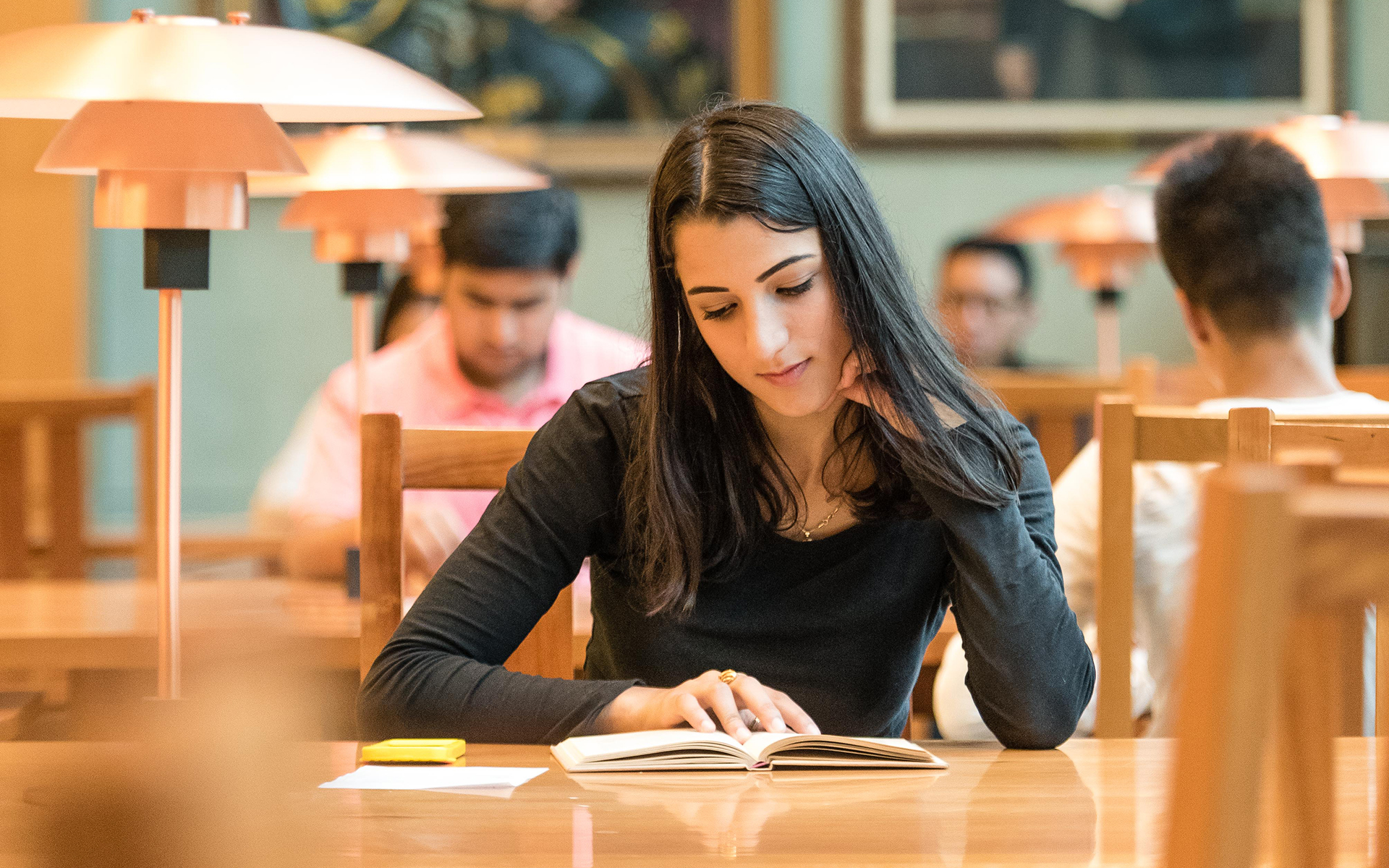 Win university. Indian girl in Britain Uni in Library.